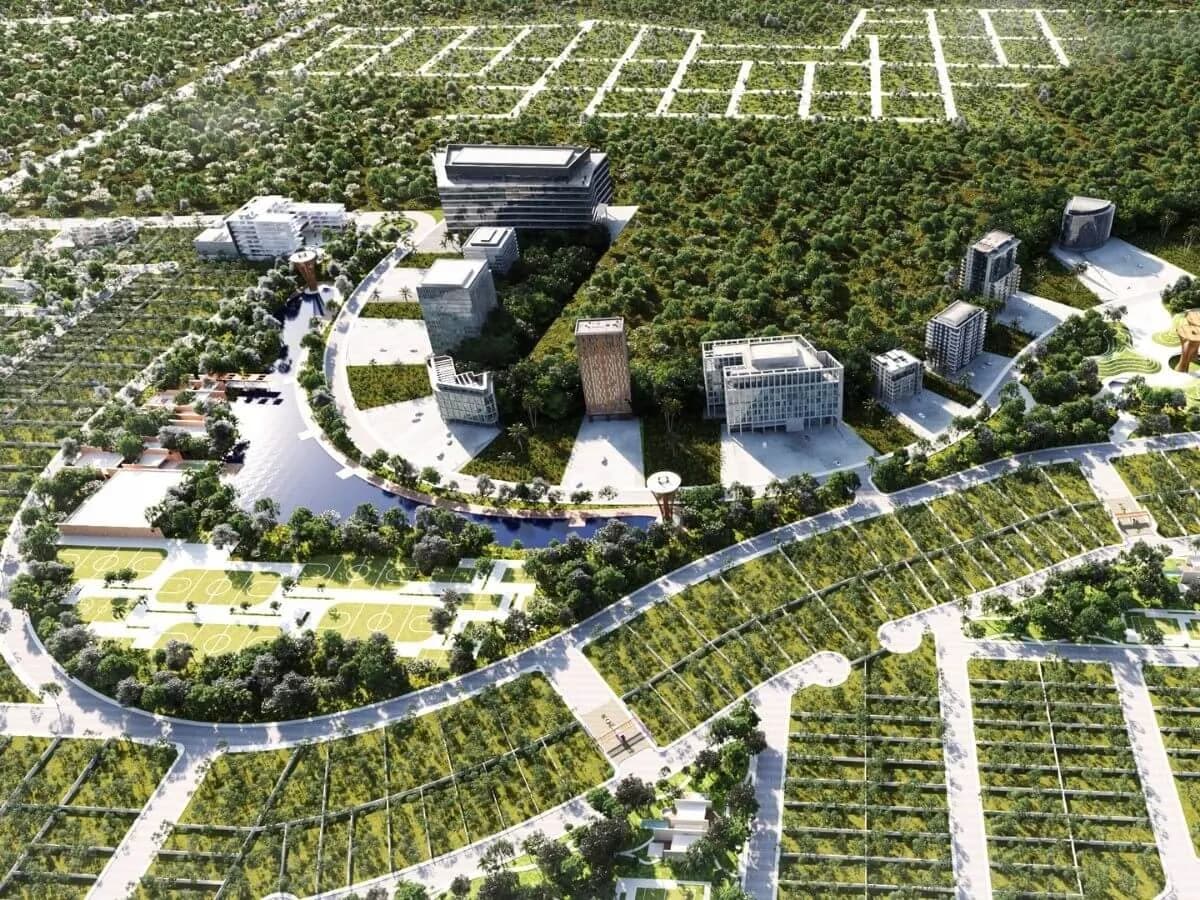 Vista aérea del desarrollo inmobiliario con edificios modernos rodeados de áreas verdes y canchas deportivas